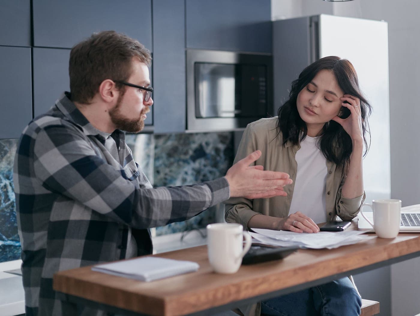 Someone looking frustrated in a kitchen with coffee